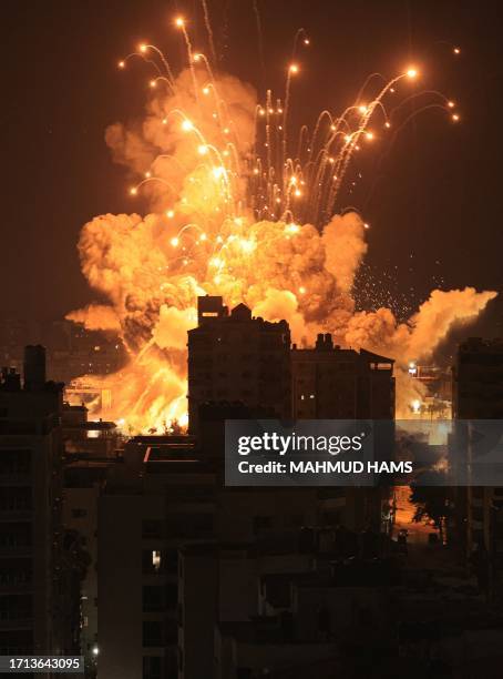 Missile explodes in Gaza City during an Israeli air strike on October 8, 2023. Srael, reeling from the deadliest attack on its territory in half a...