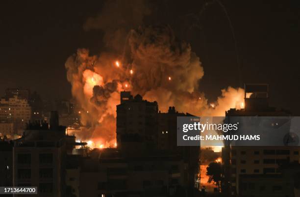 Fire and smoke rise above buildings in Gaza City during an Israeli air strike on October 8, 2023. Srael, reeling from the deadliest attack on its...