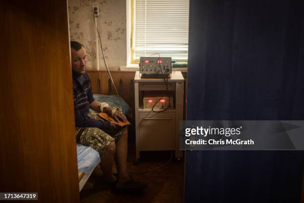 Soldier uses electronic and magnetic treatments for a shrapnel wound to his arm at a rehabilitation center working with soldiers suffering from...