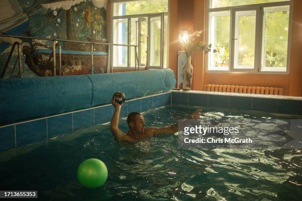 Soldier throws a ball in the pool at a rehabilitation center working with soldiers suffering from injuries and psychological trauma on October 02,...