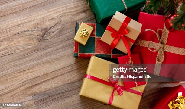 beautiful wrapped christmas presents under the tree - christmas presents under tree stock pictures, royalty-free photos & images