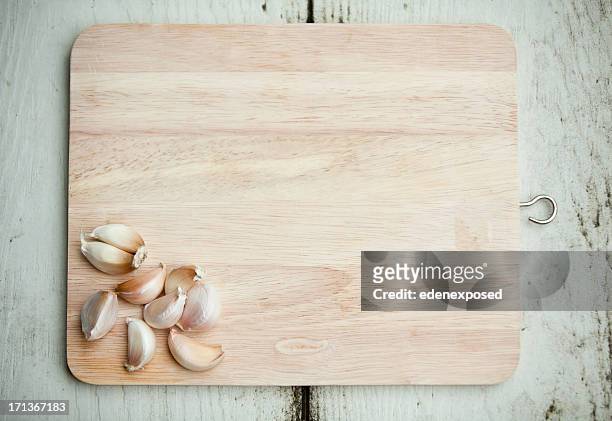 fresh garlic ready to chop on wooden chopping board. overhead. - chopping board from above stock pictures, royalty-free photos & images