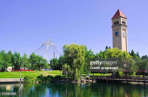a clock tower at riverfront park in spokane on a sunny day - washington state stock pictures, royalty-free photos & images