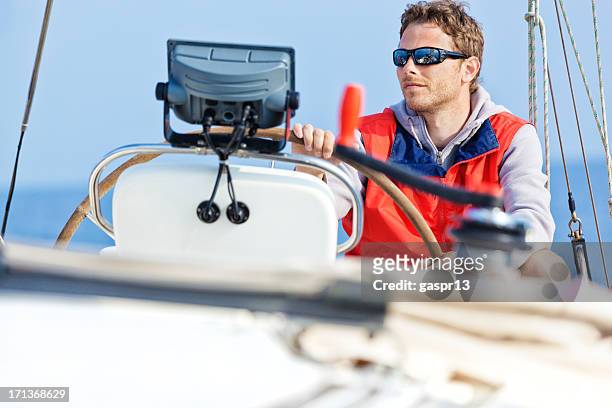 young handsome skipper behing the helm - steering boat stock pictures, royalty-free photos & images