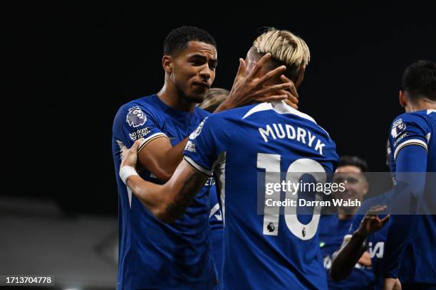 Mykhaylo Mudryk of Chelsea celebrates with teammate Levi Colwill after scoring the team's first goal during the Premier League match between Fulham...