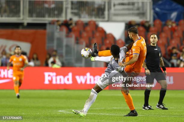 Hugo Mbongue of Toronto FC and Alvas Powell of FC Cincinnati battle for the ball during the American MLS League match between Toronto FC and FC...