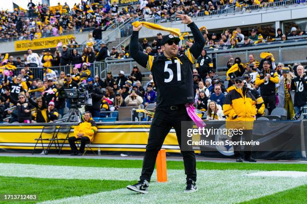 Pittsburgh Pirates pitcher David Bednar waves a terrible towel during the regular season NFL football game between the Baltimore Ravens and...