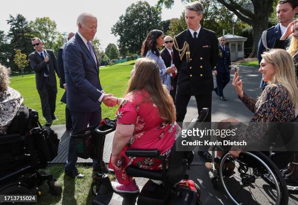 President Joe Biden greets members of the disabled community and advocates following an event honoring the Americans with Disabilities Act and...
