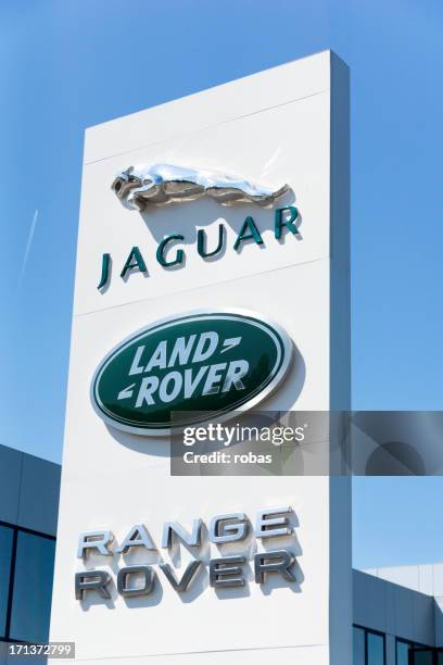 jaguar and land rover cars sign outdoors, - jaguar car stock pictures, royalty-free photos & images