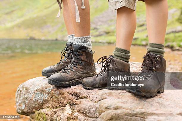 hikers standing on rock - leather boots stock pictures, royalty-free photos & images
