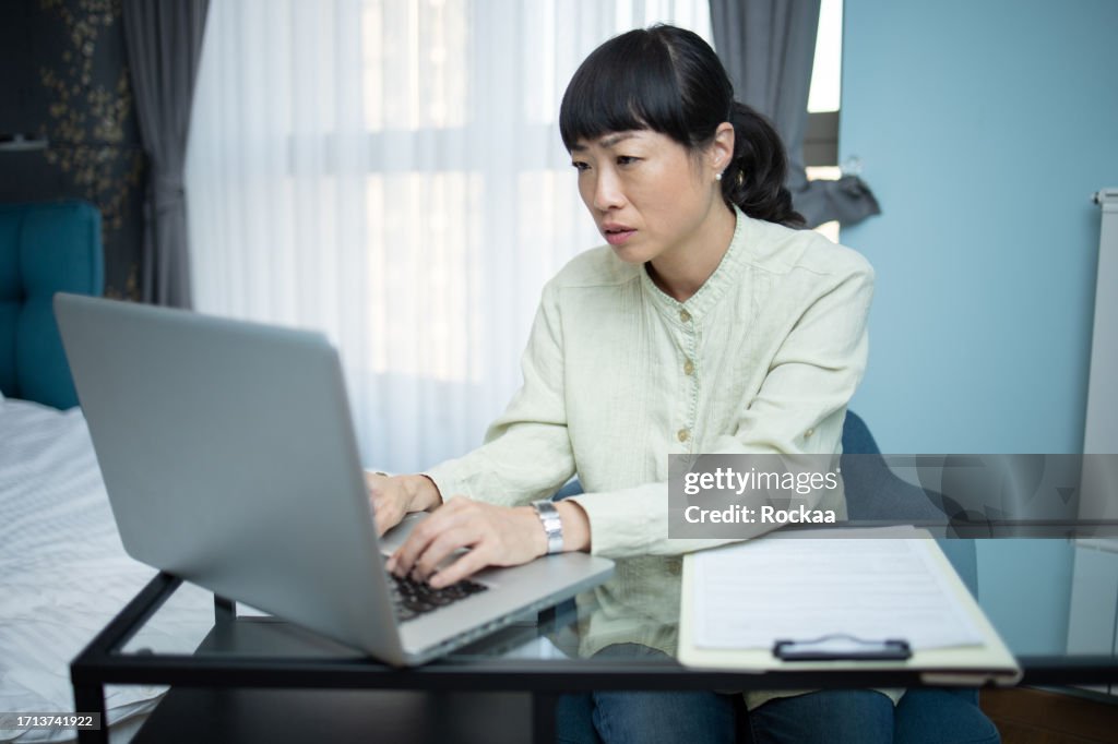 Nervous woman using a laptop