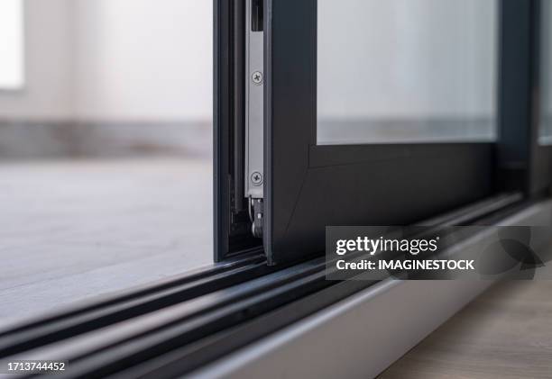 close-up of an anthracite gray aluminum window with glass in a new house - aluminium stock pictures, royalty-free photos & images