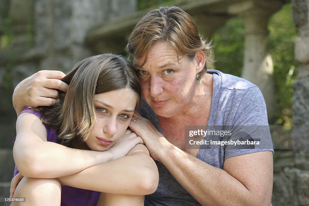 Child being embraced by her mother.