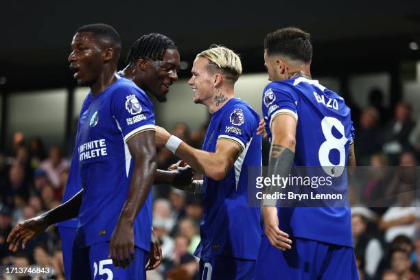 Mykhaylo Mudryk of Chelsea celebrates with teammate Axel Disasi after scoring the team's first goal during the Premier League match between Fulham FC...