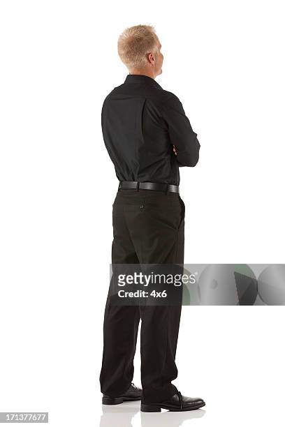 businessman standing with his arms crossed - black trousers stockfoto's en -beelden