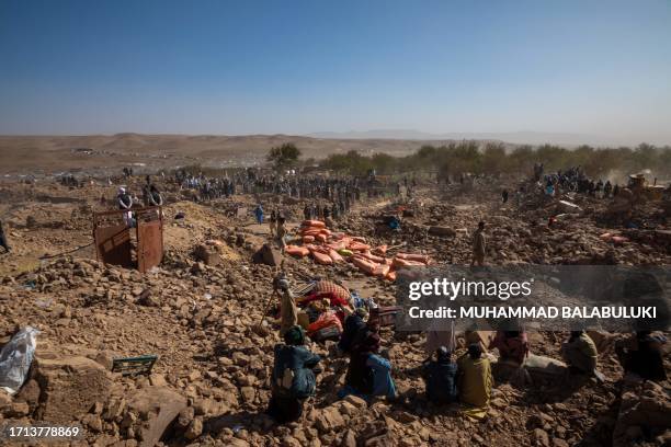 Herat, Afghanistan. Afghans excavate the ruins of demolished buildings to recover bodies after the massive 6.3 magnitude earthquake hits the city of...