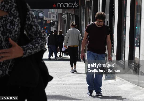 Pedestrian carries a shopping bag while walking through the Union Square shopping district on October 02, 2023 in San Francisco, California....