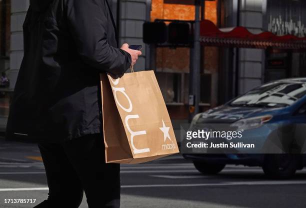 Pedestrian carries a shopping bag while walking through the Union Square shopping district on October 02, 2023 in San Francisco, California....