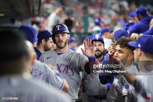 Jonah Heim of the Texas Rangers celebrates his run in the eighth inning against the Los Angeles Angels at Angel Stadium of Anaheim on September 25,...