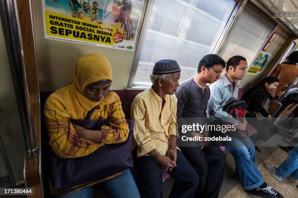 people sitting on a train in jakarta, indonesia - indonesiskt ursprung bildbanksfoton och bilder