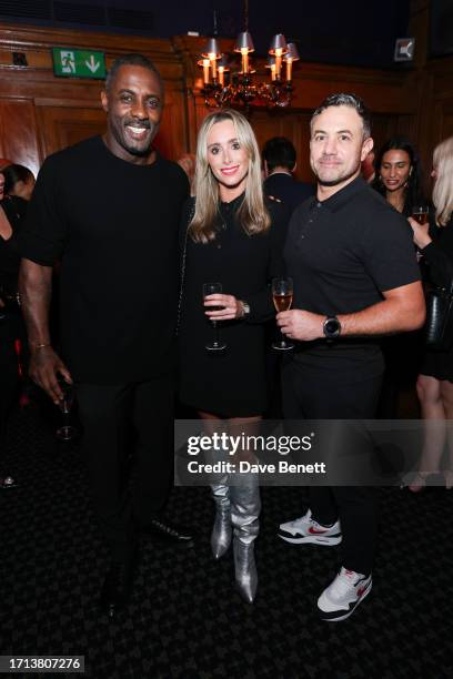 Idris Elba, Anna Woolhouse and Warren Brown attend the reveal of Porte Noire's new Petit Porte Noire Rose Champagne at Tramp on October 2, 2023 in...