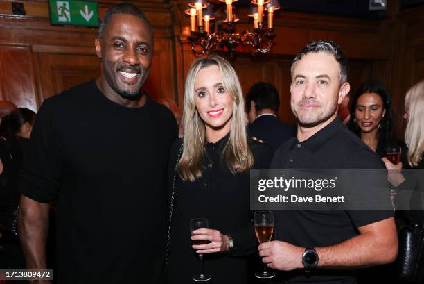 Idris Elba, Anna Woolhouse and Warren Brown attend the reveal of Porte Noire's new Petit Porte Noire Rose Champagne at Tramp on October 2, 2023 in...