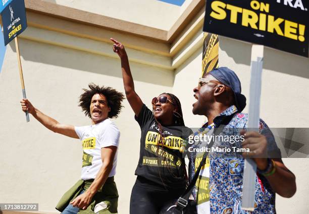 Seth Paradox, Di Smith and Charles Reese chant as striking SAG-AFTRA members picket with WGA members marching in solidarity outside Paramount Studios...