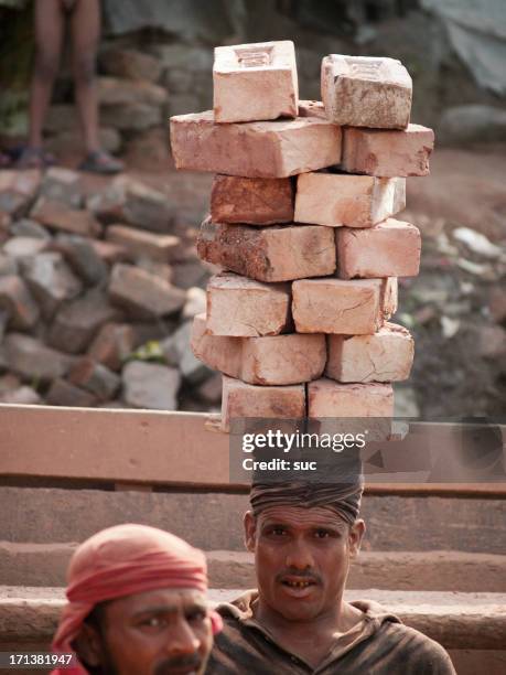 bengali man carrying bricks on his head - kiln stock pictures, royalty-free photos & images