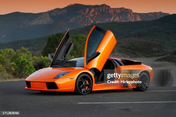 lamborghini murcielago au coucher du soleil avec des portes ouvertes - lamborghini murcielago photos et images de collection