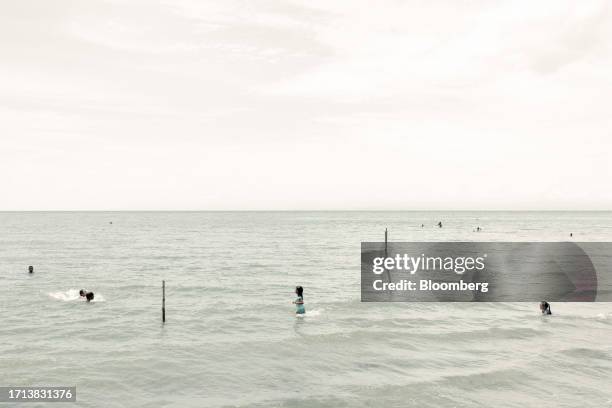 Children swim on a beach in Necocli, Antioquia department, Colombia, on Saturday, Oct. 7, 2023. The number of migrants trying to reach the US border...