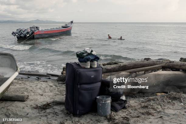 Migrant leaves personal belonging while swimming on a beach in Necocli, Antioquia department, Colombia, on Saturday, Oct. 7, 2023. The number of...