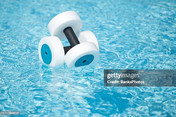 water fitness hand buoys floating in pool - aquagym stock pictures, royalty-free photos & images