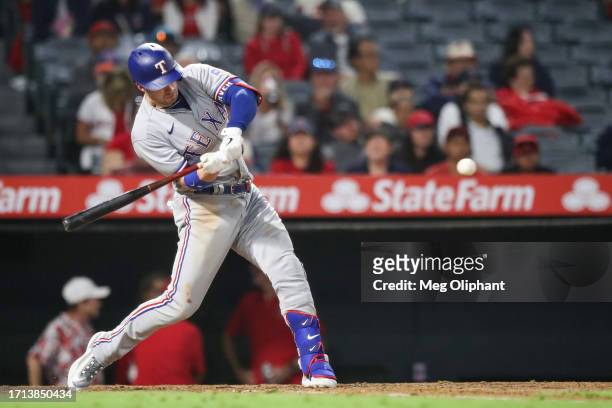 Mitch Garver of the Texas Rangers singles in the eighth inning against the Los Angeles Angels at Angel Stadium of Anaheim on September 25, 2023 in...