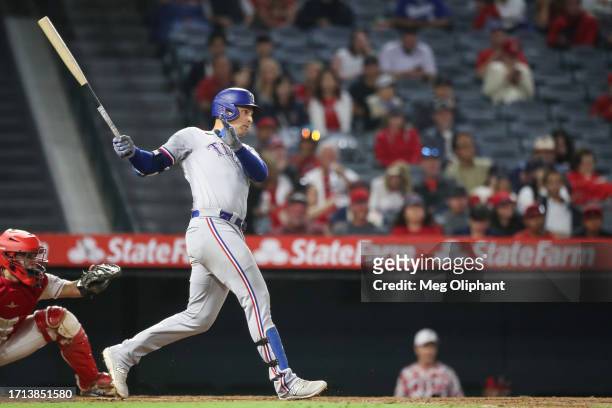 Nathaniel Lowe of the Texas Rangers watches his hit in the eighth inning against the Los Angeles Angels at Angel Stadium of Anaheim on September 25,...