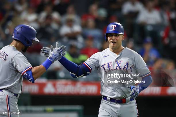 Nathaniel Lowe of the Texas Rangers celebrates his home run with Leody Taveras in the sixth inning against the Los Angeles Angels at Angel Stadium of...