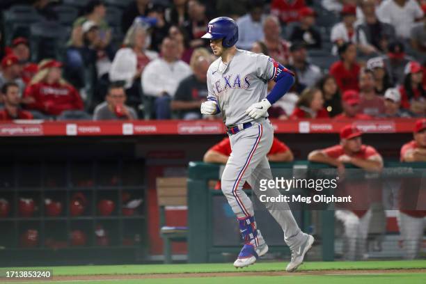 Mitch Garver of the Texas Rangers scores a home run in the sixth inning against the Los Angeles Angels at Angel Stadium of Anaheim on September 25,...