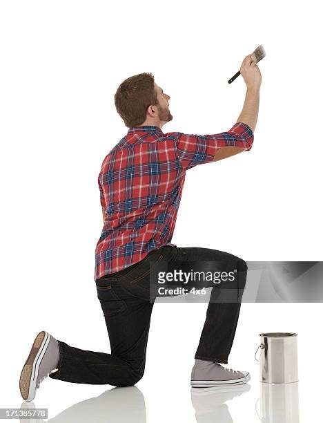 man painting a wall - kneeling stock pictures, royalty-free photos & images