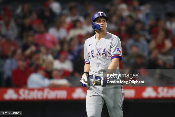 Corey Seager of the Texas Rangers reacts after striking out in the third inning against the Los Angeles Angels at Angel Stadium of Anaheim on...