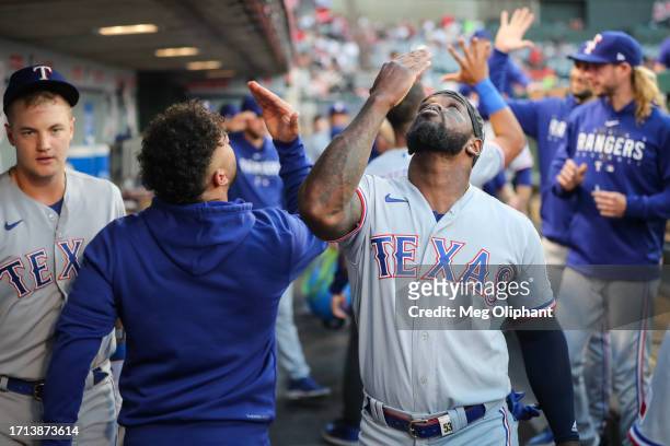 Adolis Garcia of the Texas Rangers interacts with teammates in the dugout before the game against the Los Angeles Angels at Angel Stadium of Anaheim...