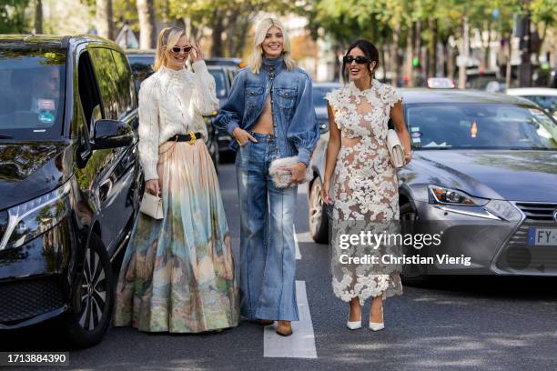 Nadine Leopold wears white knit, skirt with graphic print, Hermes bag & Devon Windsor wears denim jacket, flared jeans & Bettina Looney wears white...