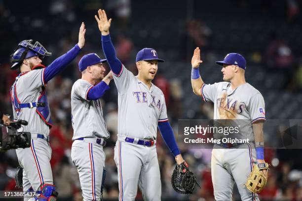 Jonah Heim, Nathaniel Lowe, and Josh Jung of the Texas Rangers react after defeating the Los Angeles Angels at Angel Stadium of Anaheim on September...