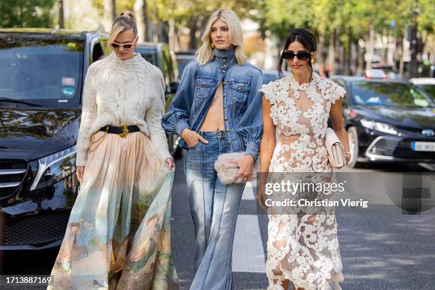 Nadine Leopold wears white knit, skirt with graphic print, Hermes bag & Devon Windsor wears denim jacket, flared jeans & Bettina Looney wears white...
