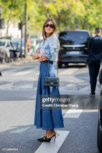 Darja Barannik wears high waisted denim skirt, button shirt, Chanel bag outside Zimmermann during the Womenswear Spring/Summer 2024 as part of Paris...