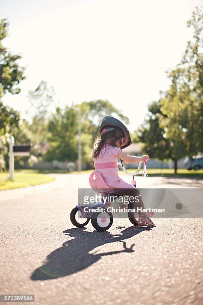little girl on a tricycle - tricycle stock-fotos und bilder