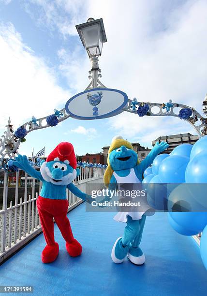 In this handout image provided by Sony Pictures Entertainment, Papa Smurf and Smurfette pose on The Ha'penny Bridge during Global Smurfs Day 2013...
