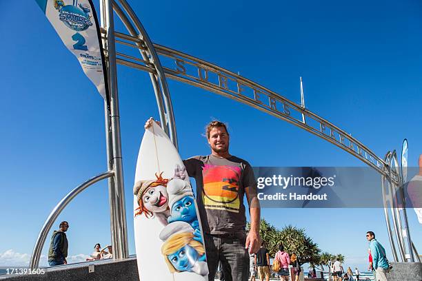 In this handout image provided by Sony Pictures Entertainment, surfer Mark Occhilupo at Global Smurfs Day 2013 celebration "Smurfers Paradise" in...