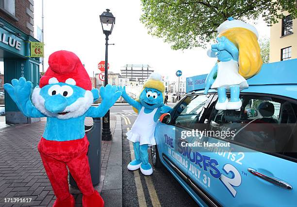 In this handout image provided by Sony Pictures Entertainment, Papa Smurf and Smurfette pose during Global Smurfs Day 2013 celebration on June 22,...