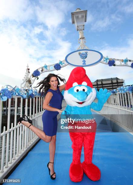 In this handout image provided by Sony Pictures Entertainment, model Michelle McGrath poses with Papa Smurf on The Ha'penny Bridge during Global...