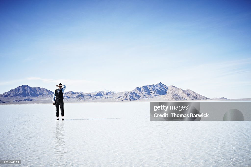 Businessman standing alone in shallow water