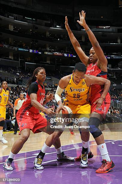 Marissa Coleman of the Los Angeles Sparks splits defense of Tierra Ruffin-Pratt and Nadirah McKenith of the Washington Mystics during the game at...